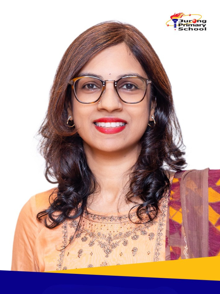 Smiling woman in yellow outfit, glasses, long curly dark hair.